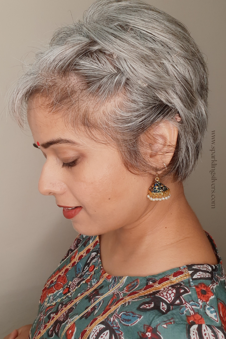 An Indian young woman with grey hair and twisted hairstyle