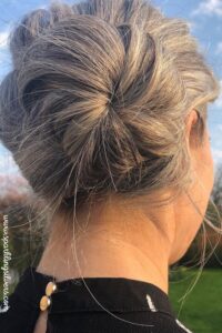 Side messy bun on grey hair