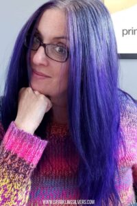 image of a woman with purple hair color and specs on