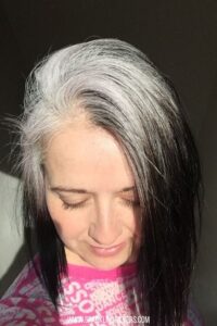 image of a woman with gray roots and black ends