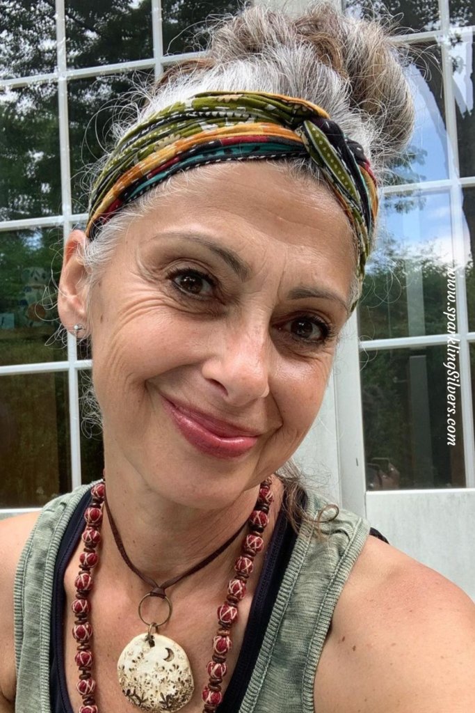 A woman with grey hair and bandana