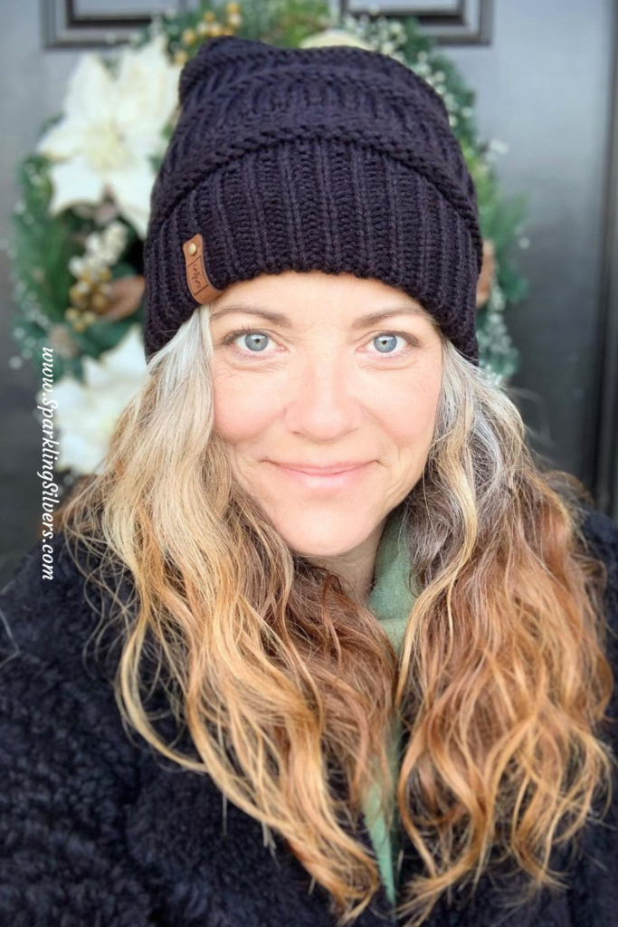 A woman with a black beanie and gray hair