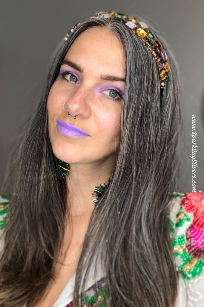 Woman with white hair and purple lipstick