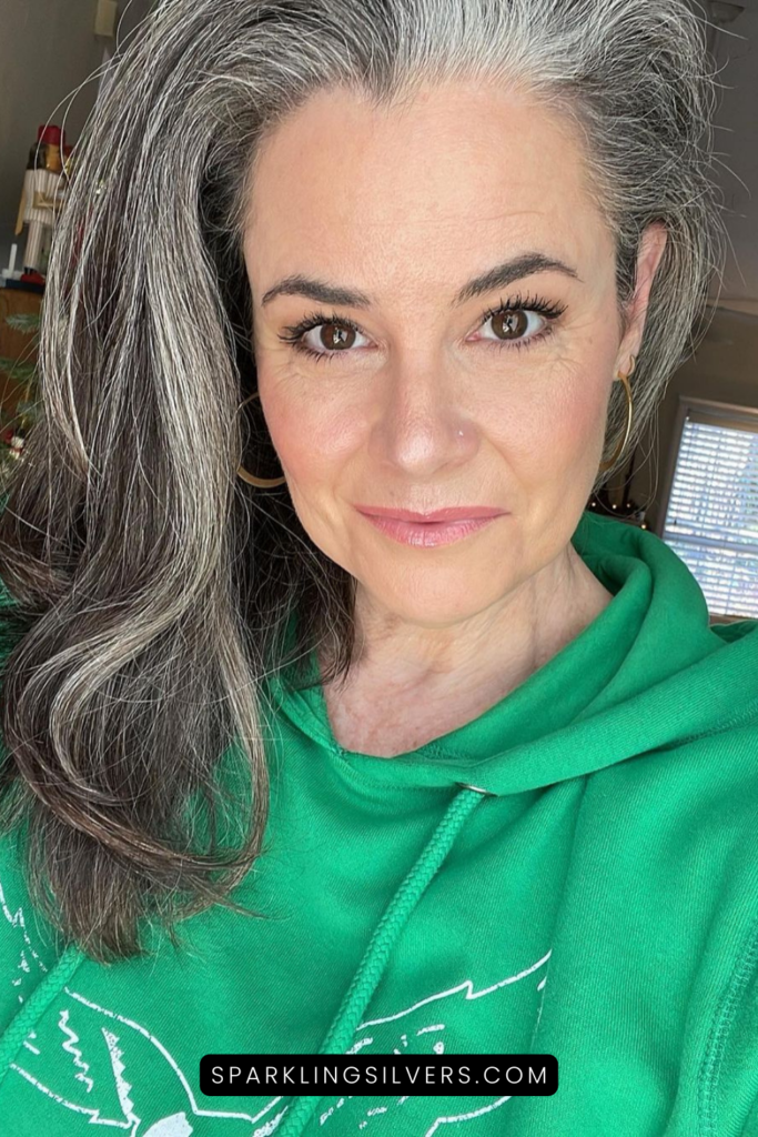 warm toned silver hair and green clothing