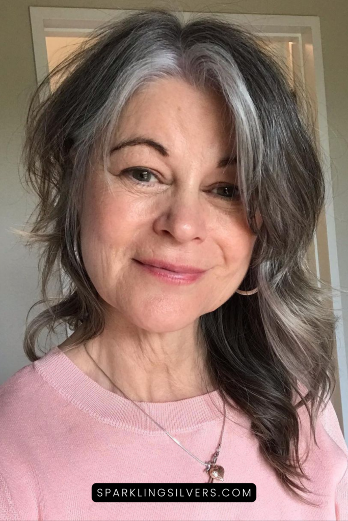 A warm toned woman with natural grey hair