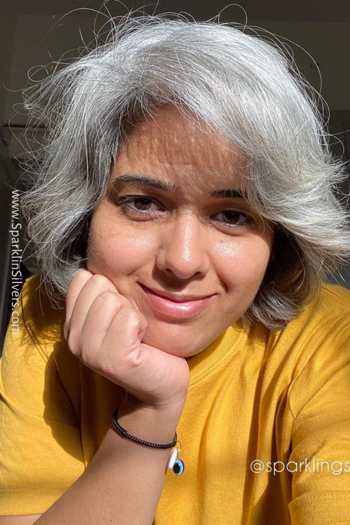 Mustard colour with warm undertone grey haired woman